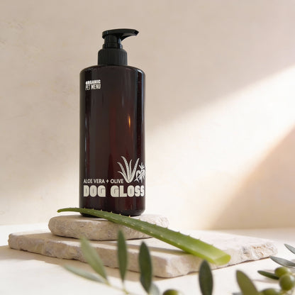 Black bottle of Dog Gloss with aloe vera and olive on a neutral background