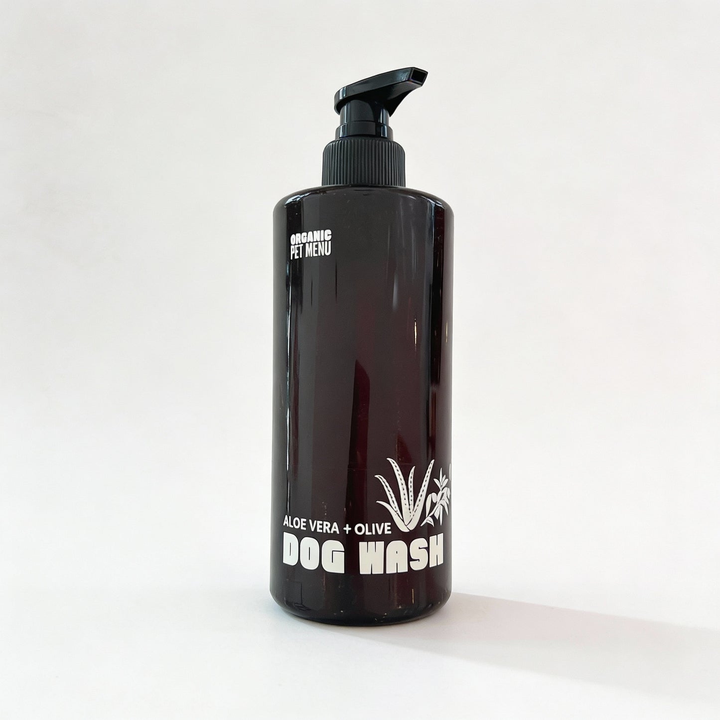 Black bottle of Organic Pet Menu Dog Wash with a pump on a white background